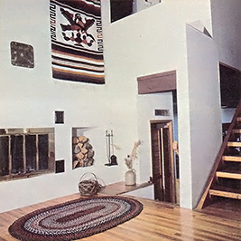 Hardwood floors and an insulated fireplace add both beauty and warmth to the den.